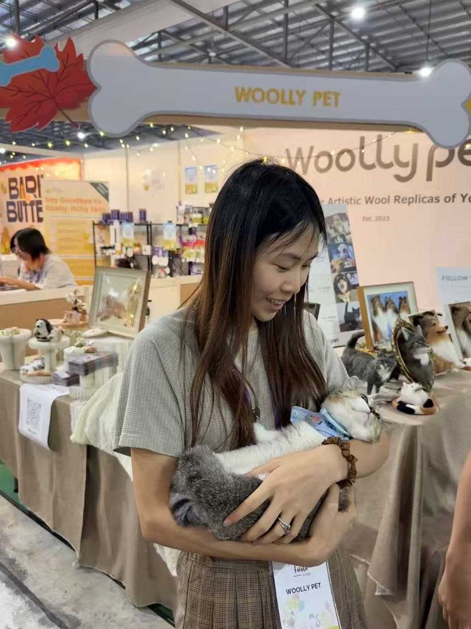 A Woolly Pet artisan holding a felted cat at Singapore Pet Expo Fiesta 2025